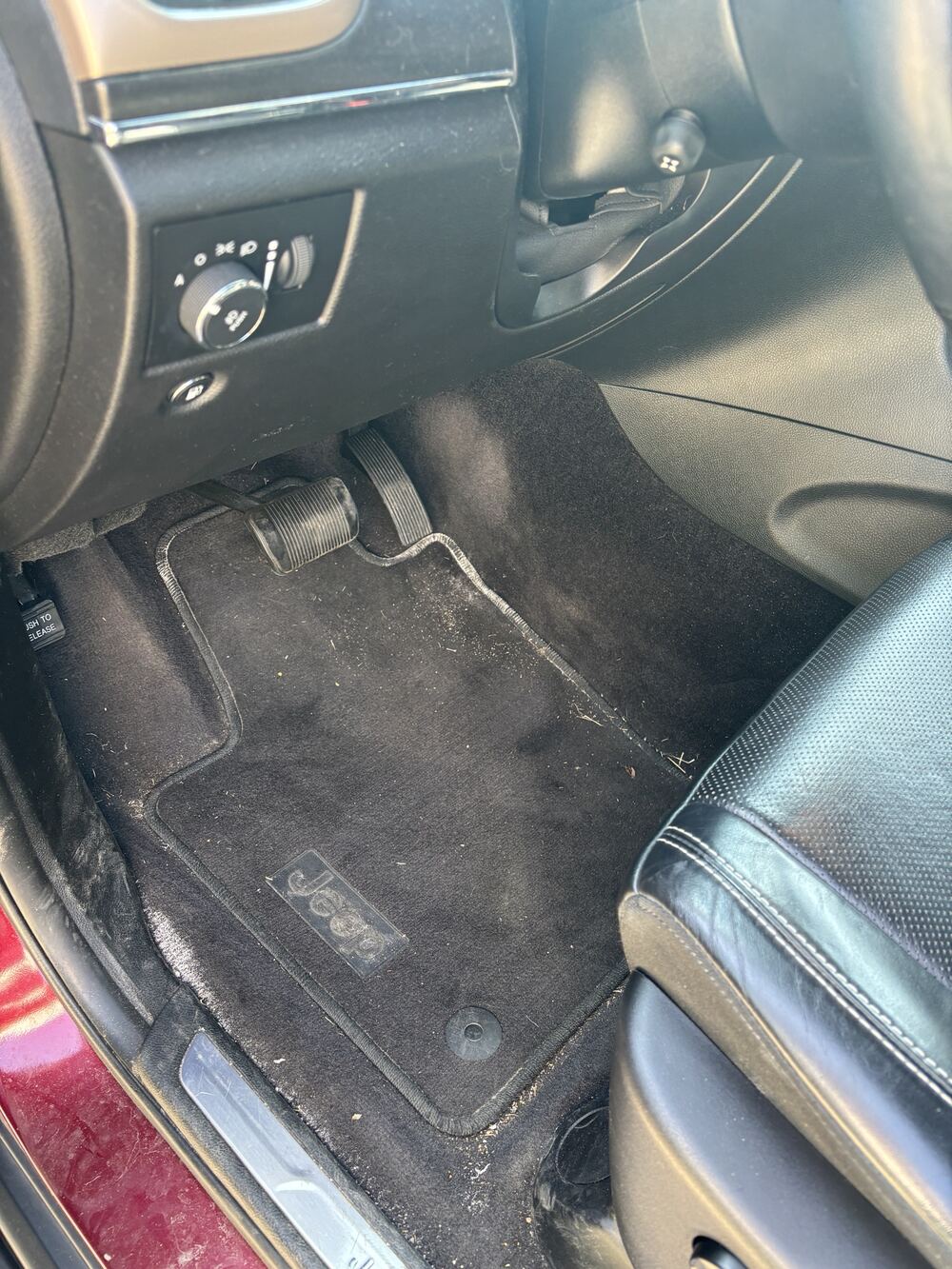 Driver-side floor before: carpet covered in dirt, salt and debris