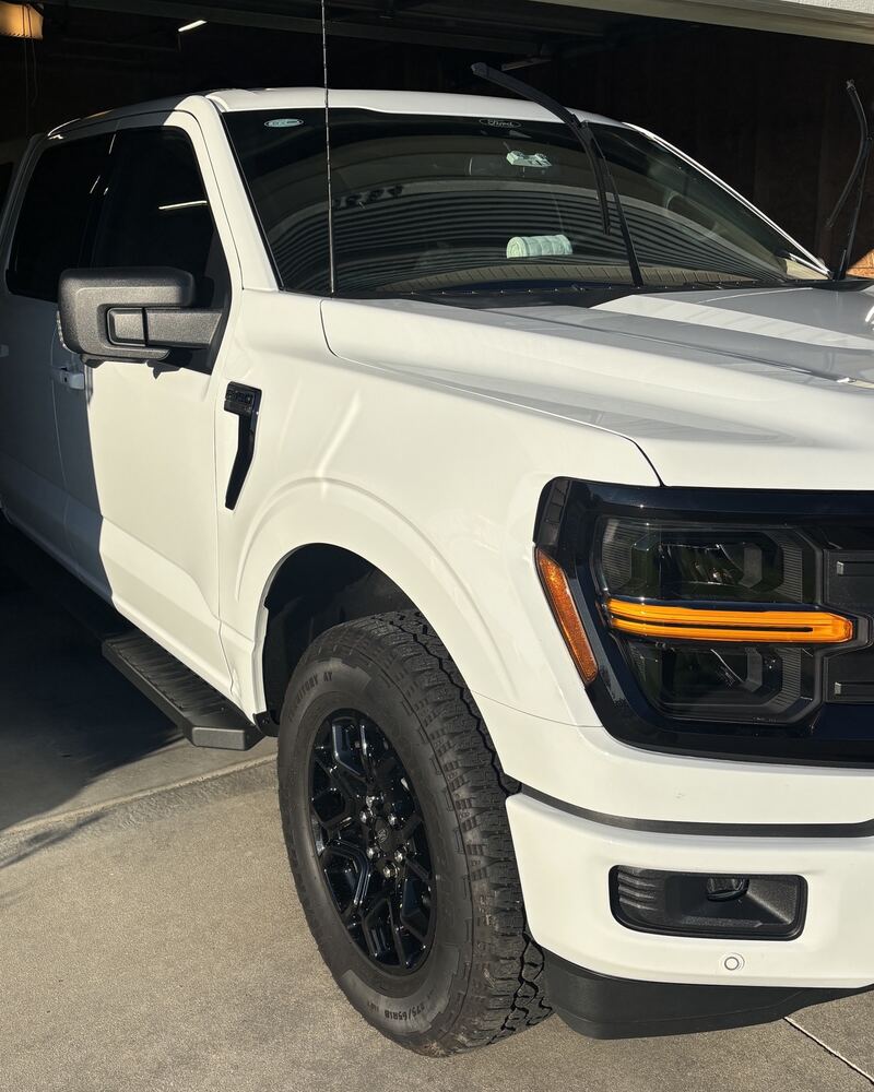 White Ford F-150 with bright, glossy coated paint and black wheels